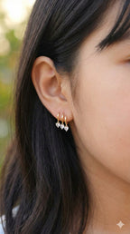 young woman wearing gold-plated hypoallergenic earrings, showing their anti-tarnish shine suitable for sensitive skin and daily wear