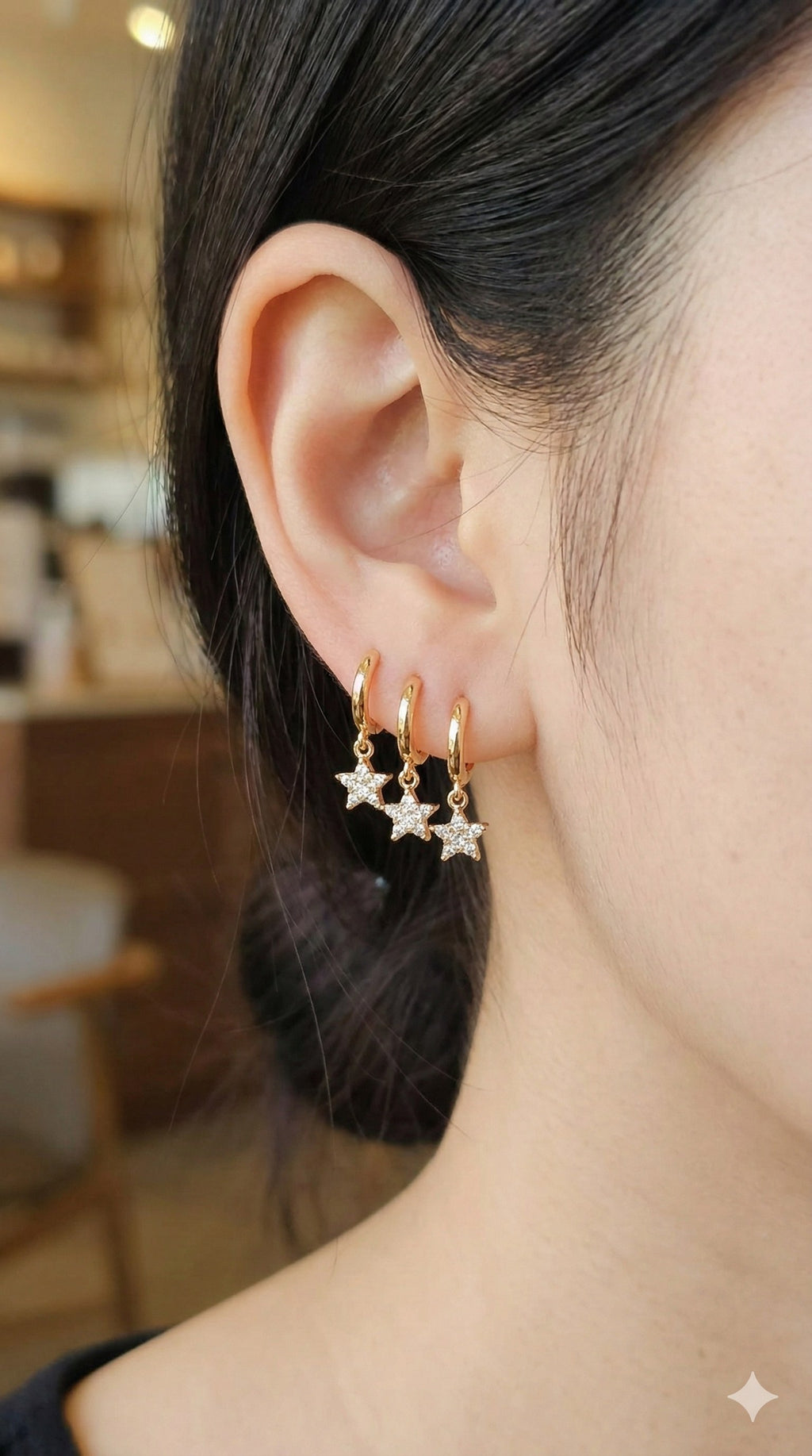 young woman wearing gold-plated hypoallergenic earrings, showing their anti-tarnish shine suitable for sensitive skin and daily wear
