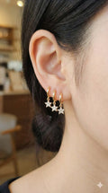 young woman wearing gold-plated hypoallergenic earrings, showing their anti-tarnish shine suitable for sensitive skin and daily wear