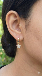 young woman wearing gold-plated hypoallergenic earrings, showing their anti-tarnish shine suitable for sensitive skin and daily wear