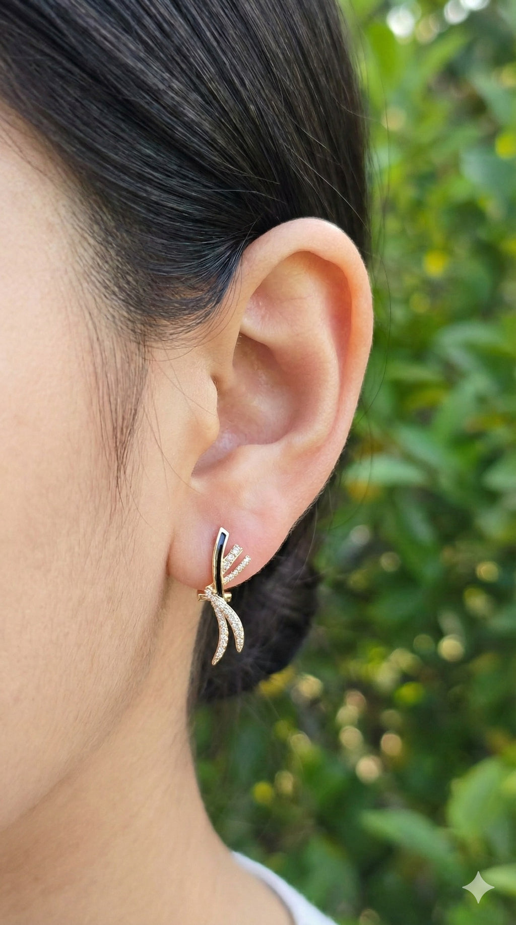 young woman wearing gold-plated hypoallergenic earrings, showing their anti-tarnish shine suitable for sensitive skin and daily wear