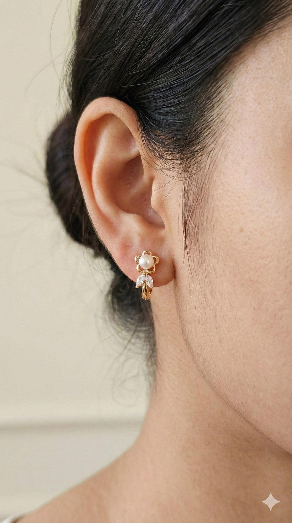 young woman wearing gold-plated hypoallergenic earrings, showing their anti-tarnish shine suitable for sensitive skin and daily wear