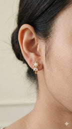 young woman wearing gold-plated hypoallergenic earrings, showing their anti-tarnish shine suitable for sensitive skin and daily wear