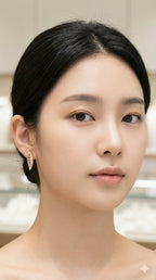 young woman wearing gold-plated hypoallergenic earrings, showing their anti-tarnish shine suitable for sensitive skin and daily wear
