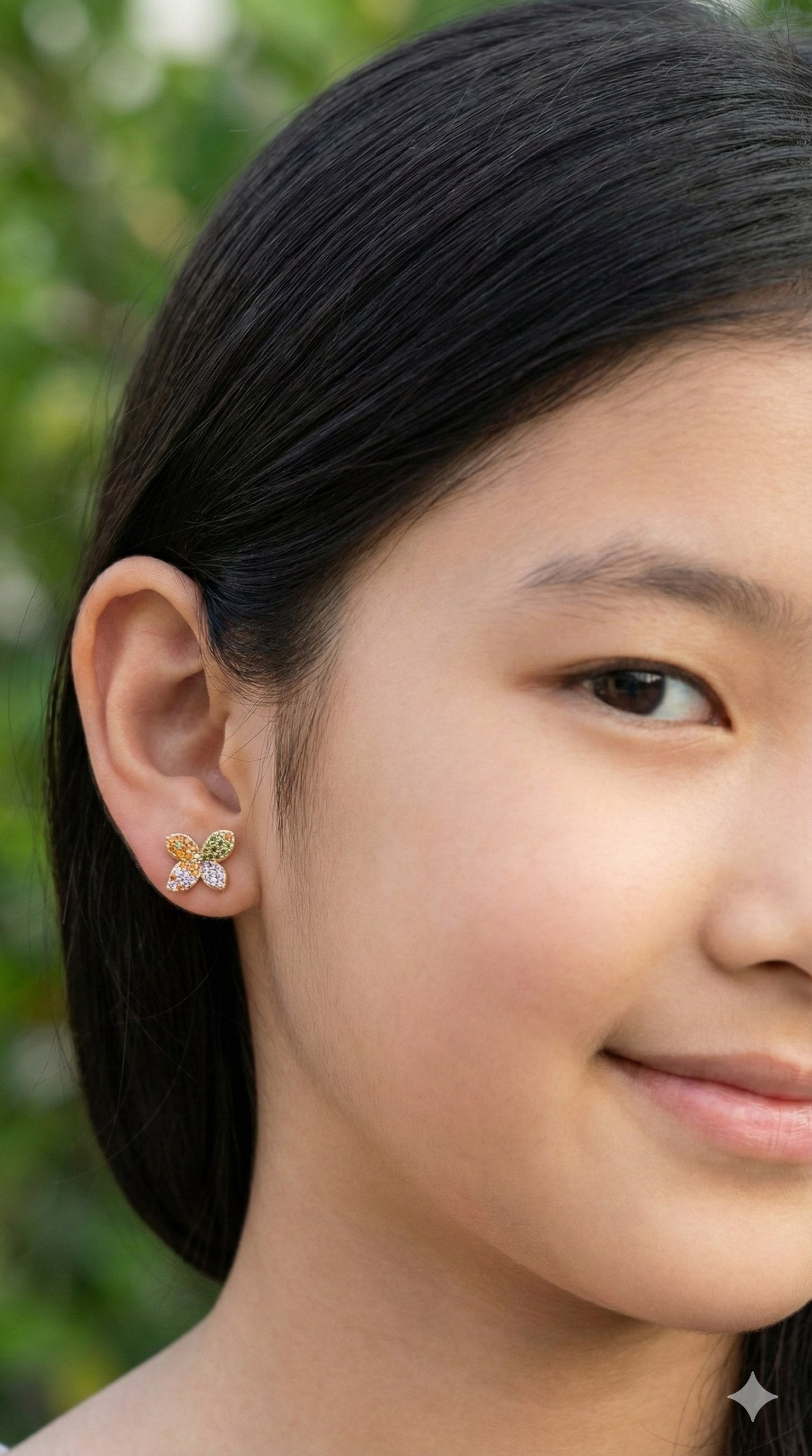 young woman wearing gold-plated hypoallergenic earrings, showing their anti-tarnish shine suitable for sensitive skin and daily wear