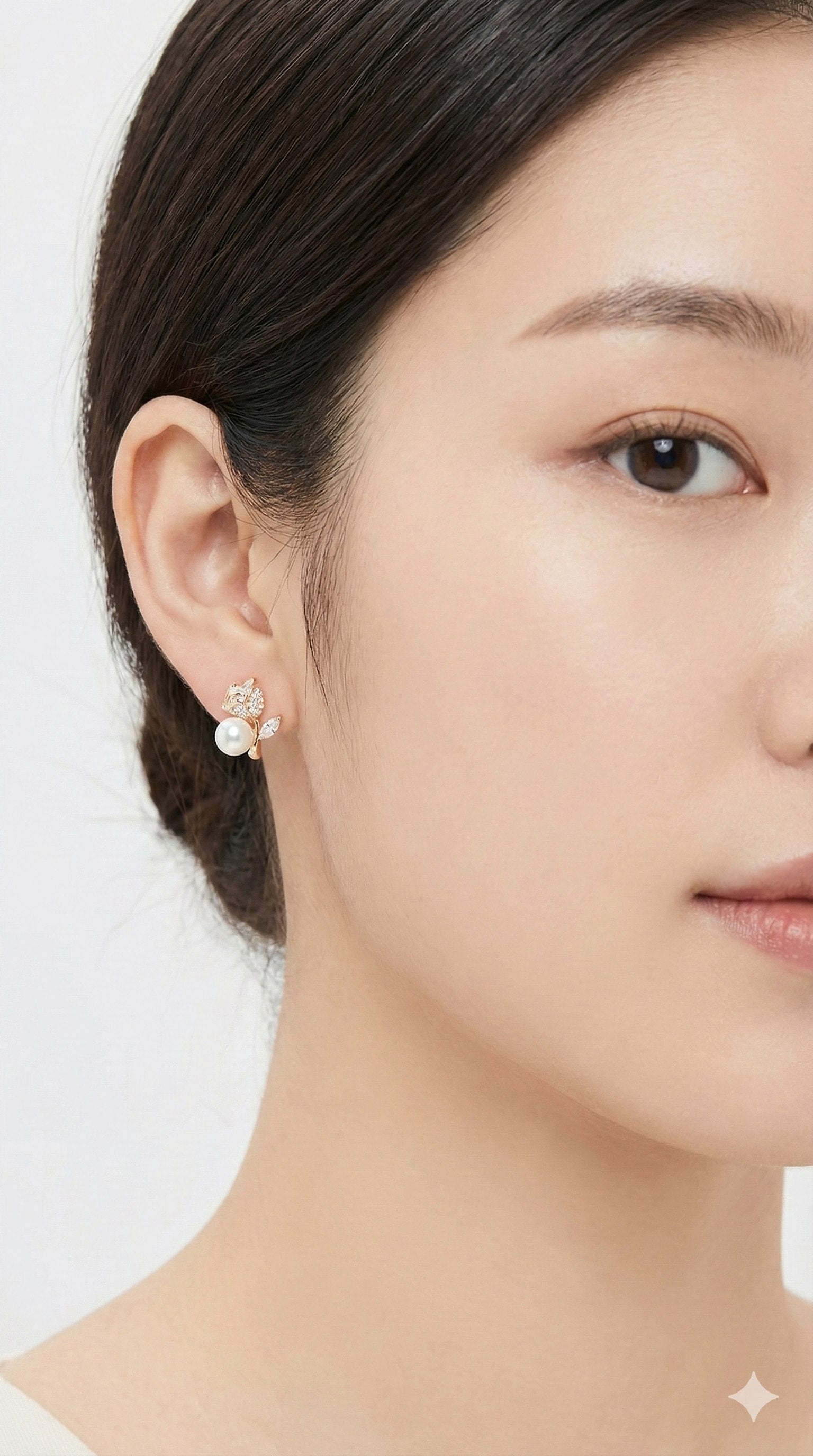 young woman wearing gold-plated hypoallergenic earrings, showing their anti-tarnish shine suitable for sensitive skin and daily wear