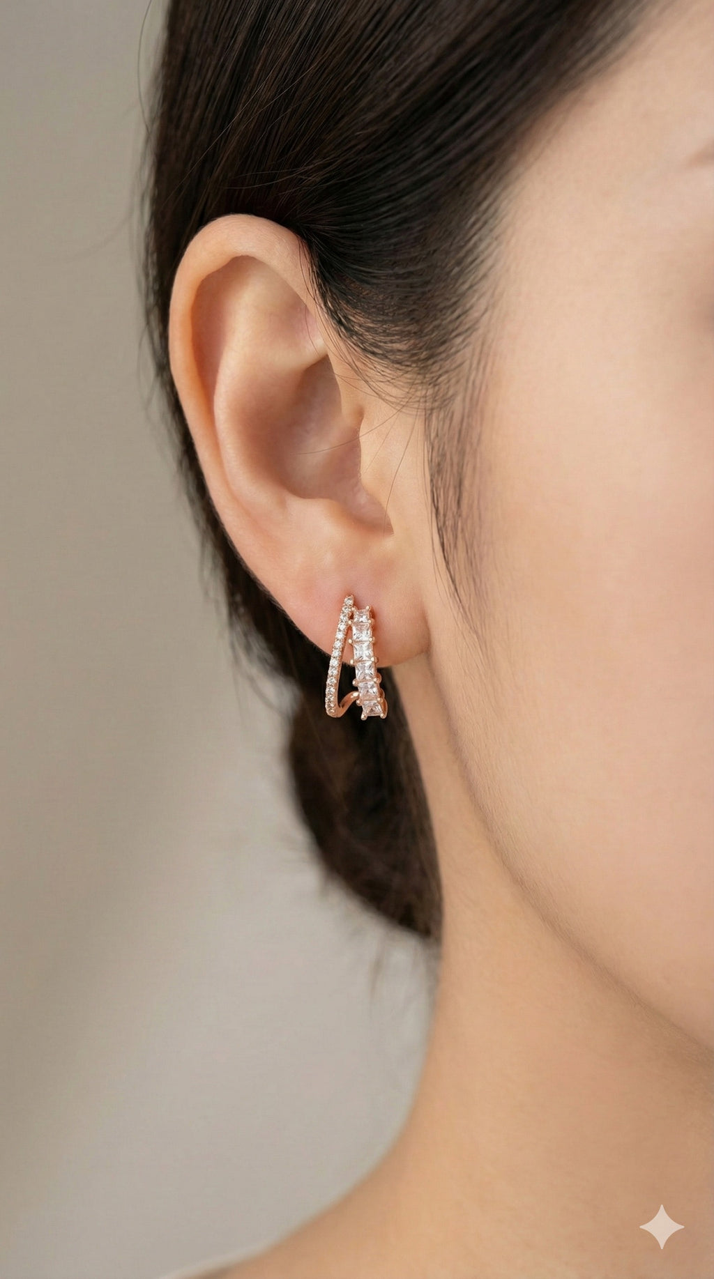 young woman wearing gold-plated hypoallergenic earrings, showing their anti-tarnish shine suitable for sensitive skin and daily wear