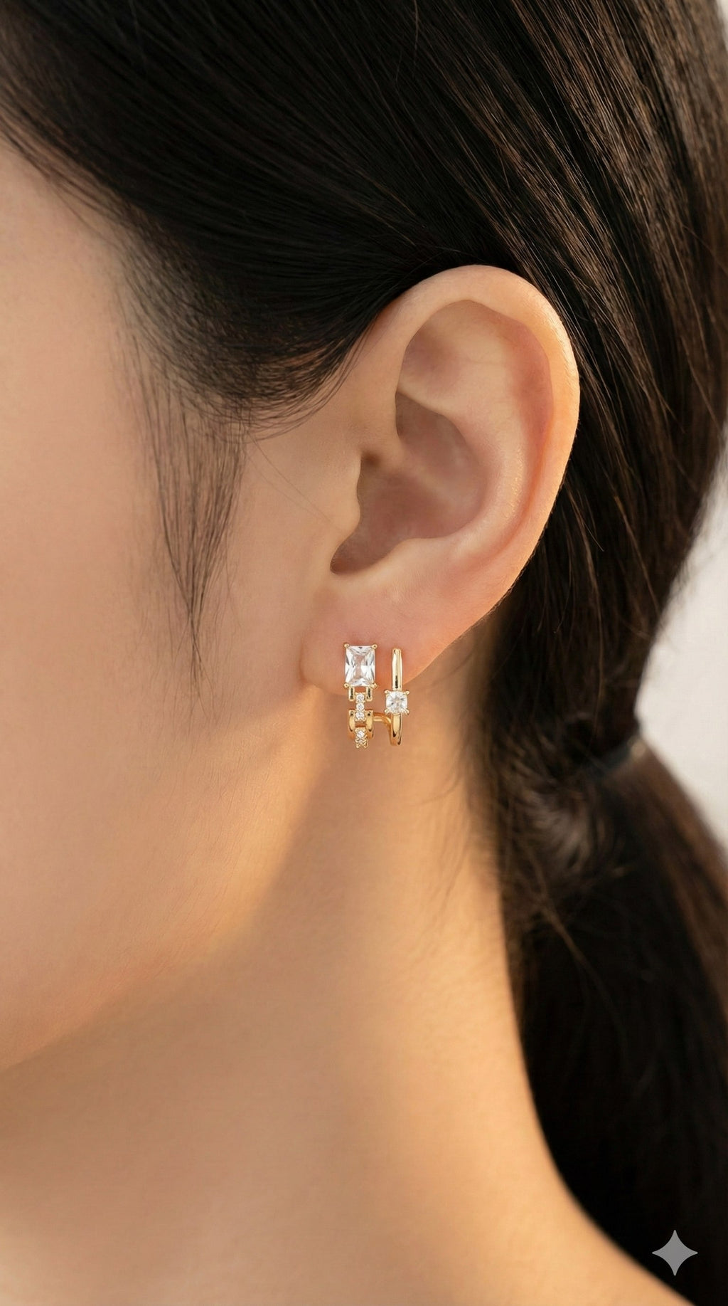 young woman wearing gold-plated hypoallergenic earrings, showing their anti-tarnish shine suitable for sensitive skin and daily wear