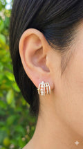young woman wearing gold-plated hypoallergenic earrings, showing their anti-tarnish shine suitable for sensitive skin and daily wear