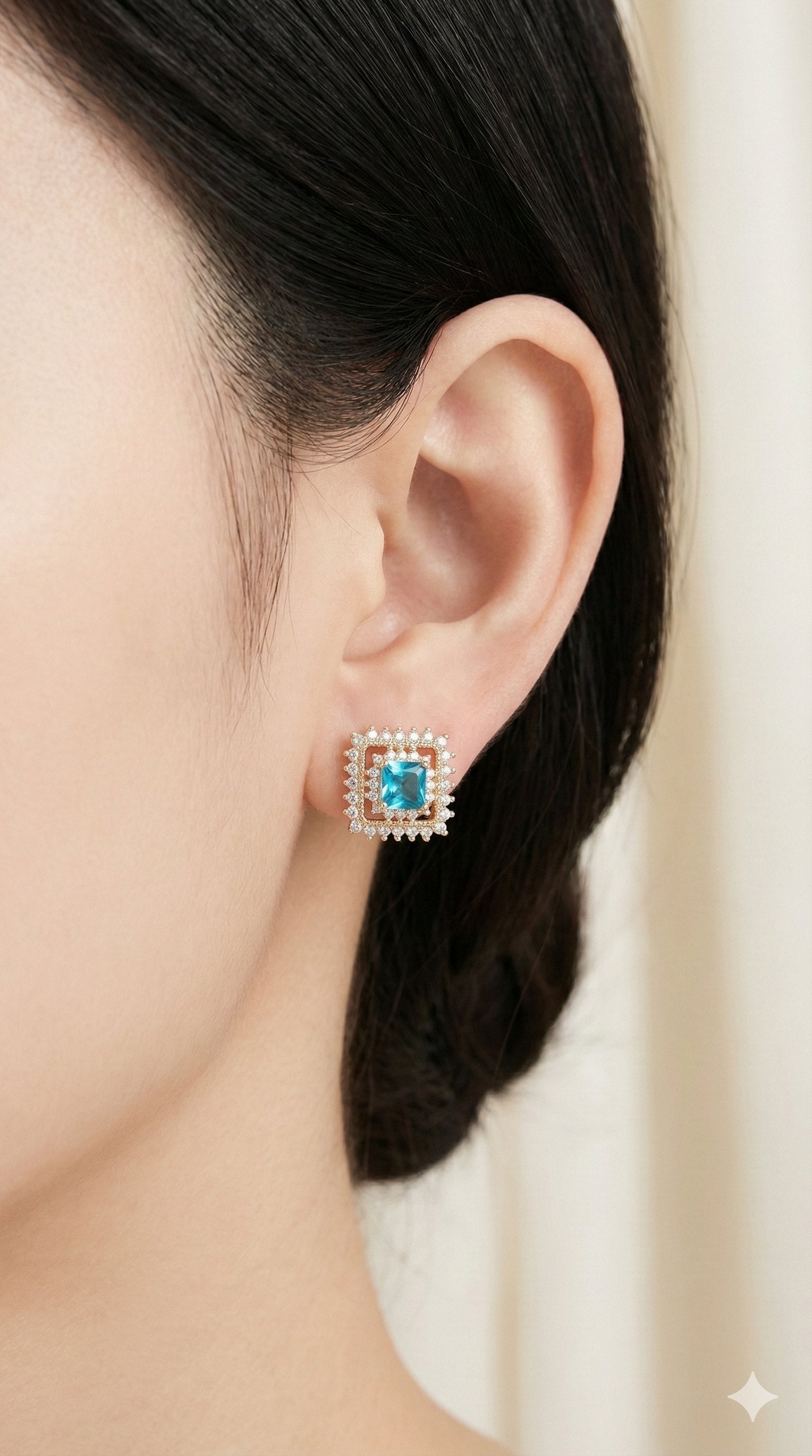 young woman wearing gold-plated hypoallergenic earrings, showing their anti-tarnish shine suitable for sensitive skin and daily wear