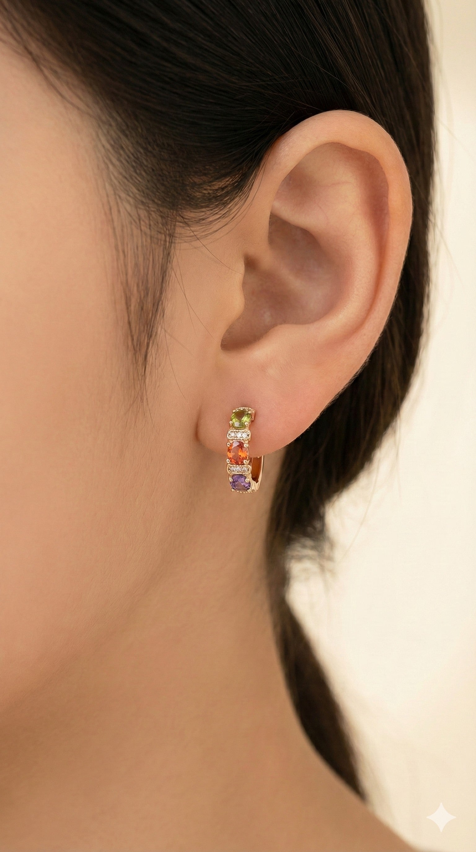young woman wearing gold-plated hypoallergenic earrings, showing their anti-tarnish shine suitable for sensitive skin and daily wear