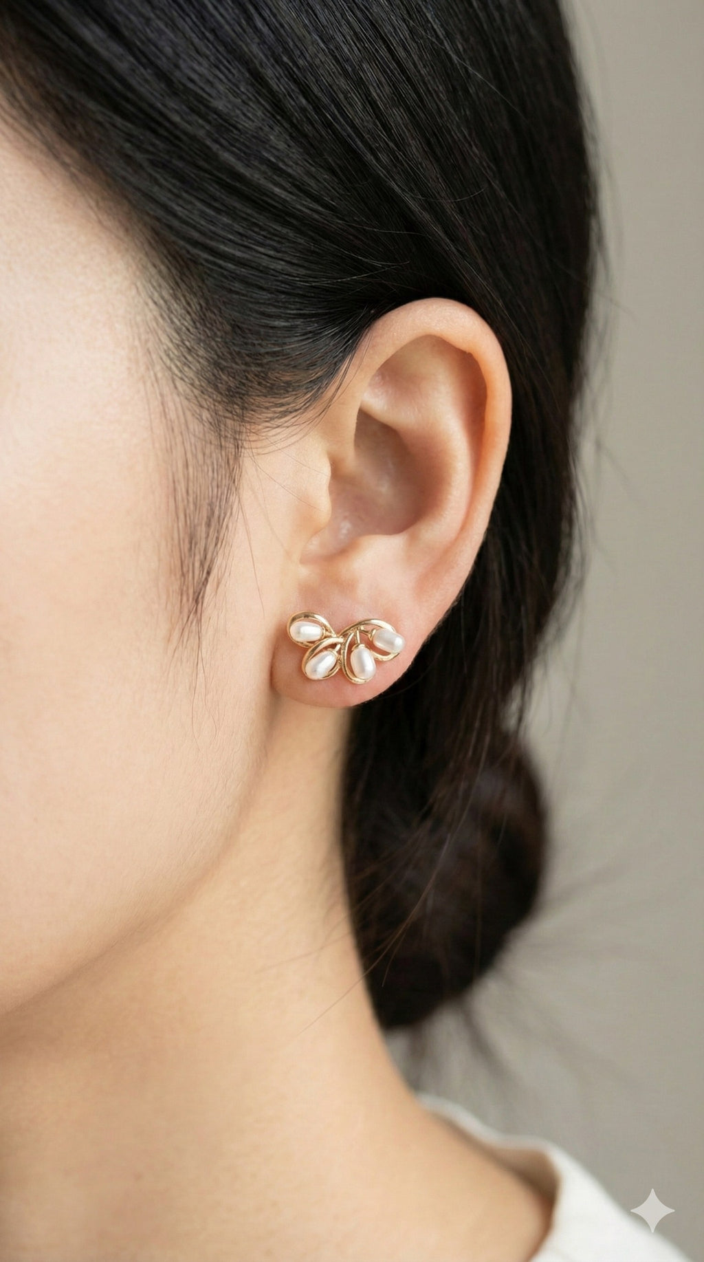 young woman wearing gold-plated hypoallergenic earrings, showing their anti-tarnish shine suitable for sensitive skin and daily wear