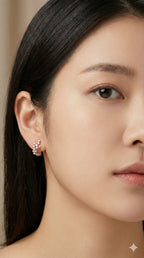 young woman wearing gold-plated hypoallergenic earrings, showing their anti-tarnish shine suitable for sensitive skin and daily wear