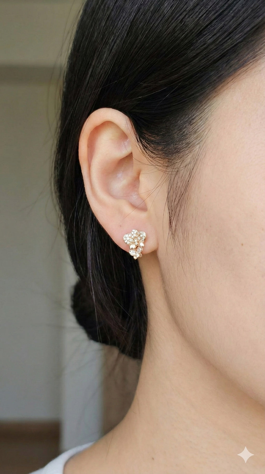 young woman wearing gold-plated hypoallergenic earrings, showing their anti-tarnish shine suitable for sensitive skin and daily wear