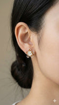 young woman wearing gold-plated hypoallergenic earrings, showing their anti-tarnish shine suitable for sensitive skin and daily wear