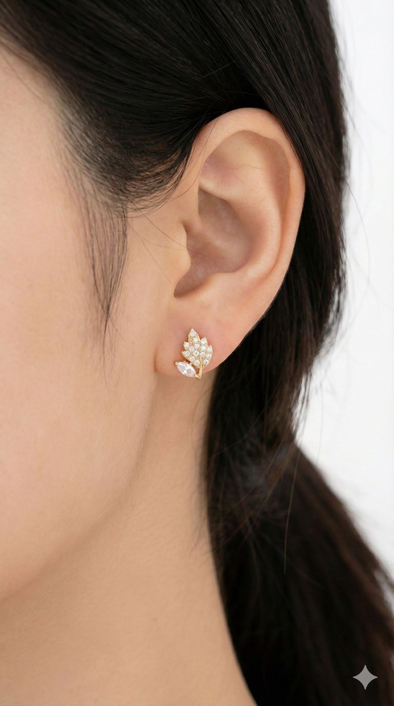 young woman wearing gold-plated hypoallergenic earrings, showing their anti-tarnish shine suitable for sensitive skin and daily wear