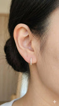 young woman wearing gold-plated hypoallergenic earrings, showing their anti-tarnish shine suitable for sensitive skin and daily wear