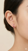 young woman wearing gold-plated hypoallergenic earrings, showing their anti-tarnish shine suitable for sensitive skin and daily wear