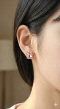 young woman wearing gold-plated hypoallergenic earrings, showing their anti-tarnish shine suitable for sensitive skin and daily wear