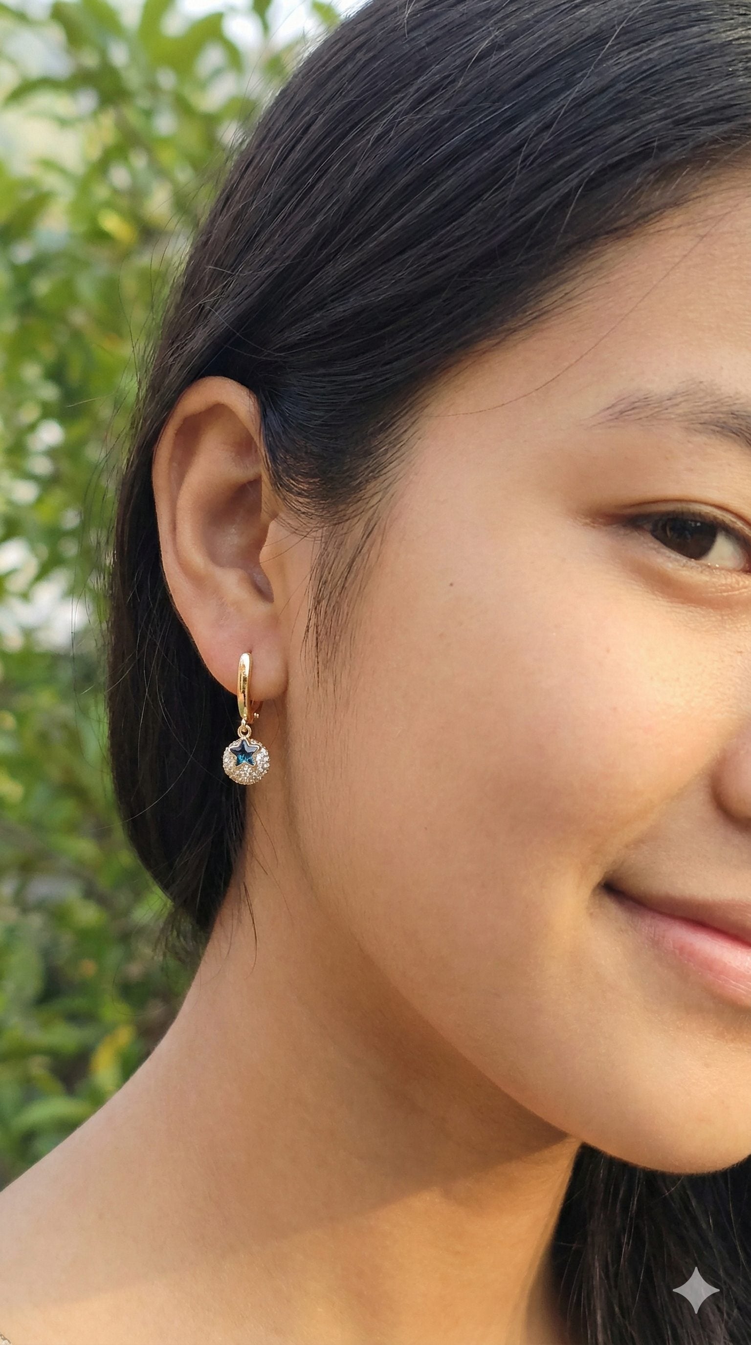 young woman wearing gold-plated hypoallergenic earrings, showing their anti-tarnish shine suitable for sensitive skin and daily wear
