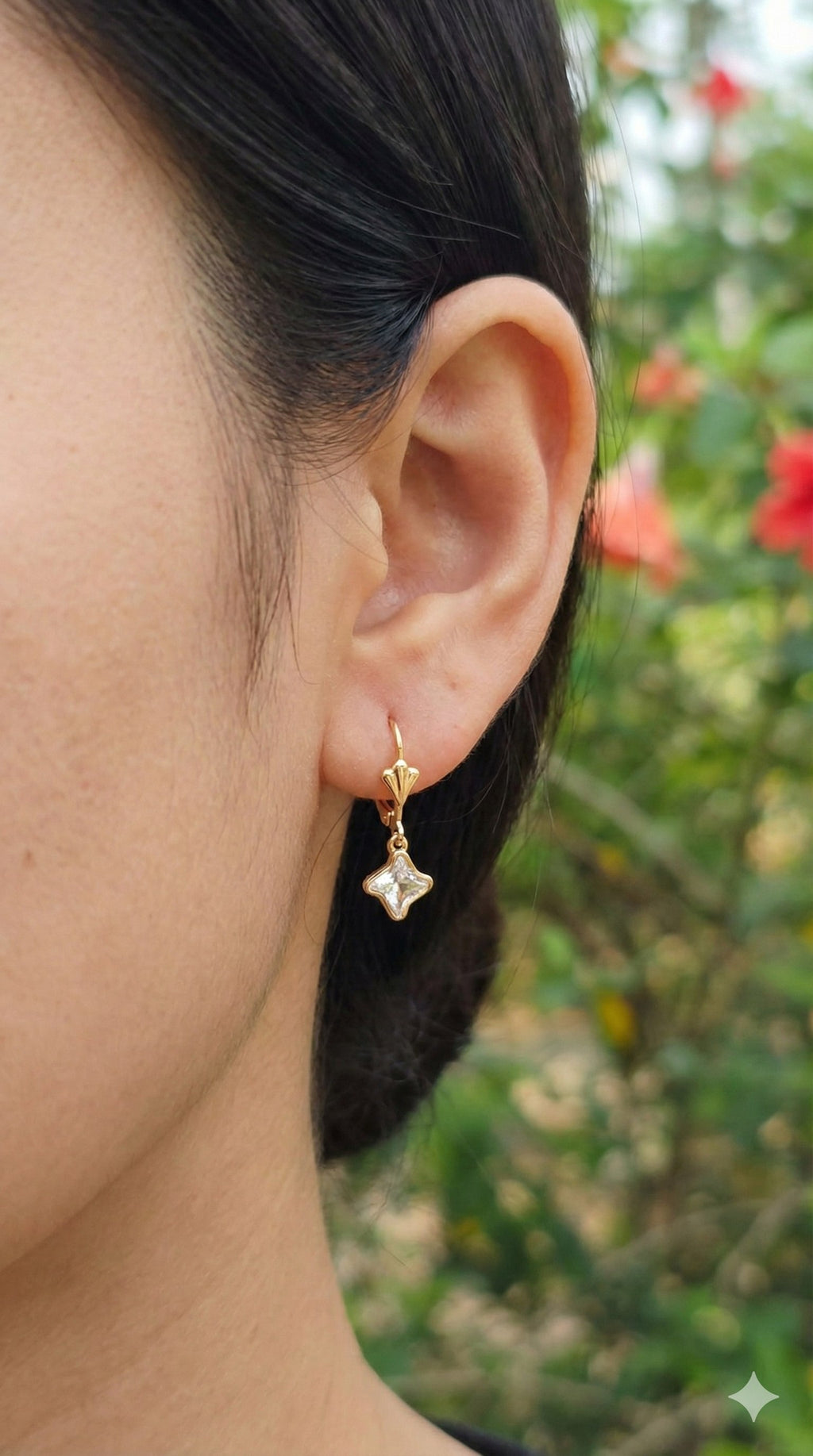 young woman wearing gold-plated hypoallergenic earrings, showing their anti-tarnish shine suitable for sensitive skin and daily wear