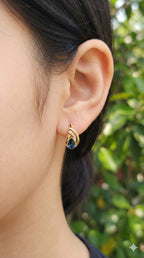 young woman wearing gold-plated hypoallergenic earrings, showing their anti-tarnish shine suitable for sensitive skin and daily wear