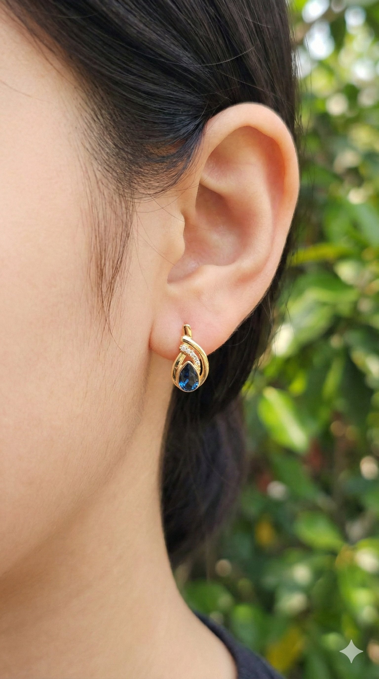young woman wearing gold-plated hypoallergenic earrings, showing their anti-tarnish shine suitable for sensitive skin and daily wear