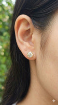 young woman wearing gold-plated hypoallergenic earrings, showing their anti-tarnish shine suitable for sensitive skin and daily wear
