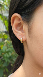 young woman wearing gold-plated hypoallergenic earrings, showing their anti-tarnish shine suitable for sensitive skin and daily wear