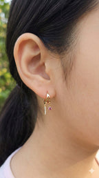 young woman wearing gold-plated hypoallergenic earrings, showing their anti-tarnish shine suitable for sensitive skin and daily wear