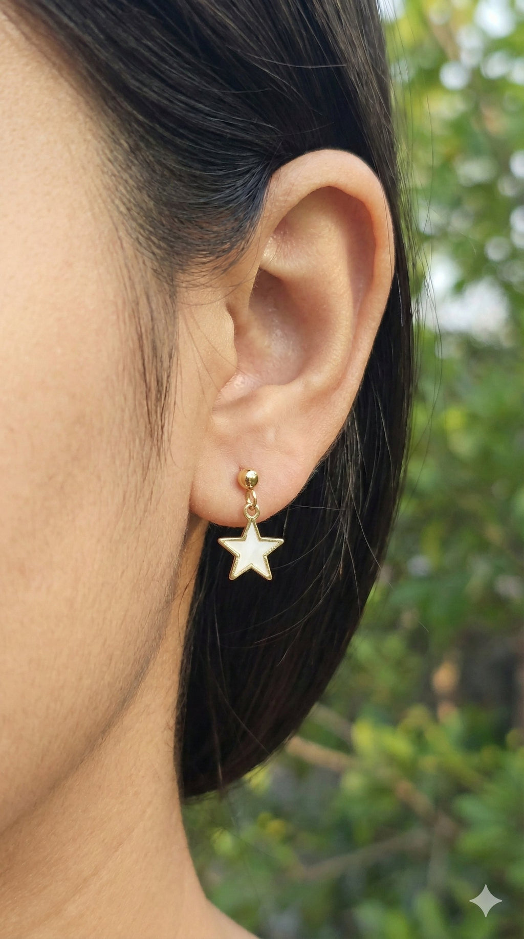 young woman wearing gold-plated hypoallergenic earrings, showing their anti-tarnish shine suitable for sensitive skin and daily wear