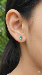 young woman wearing gold-plated hypoallergenic earrings, showing their anti-tarnish shine suitable for sensitive skin and daily wear