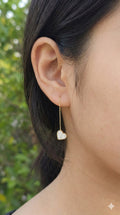 young woman wearing gold-plated hypoallergenic earrings, showing their anti-tarnish shine suitable for sensitive skin and daily wear