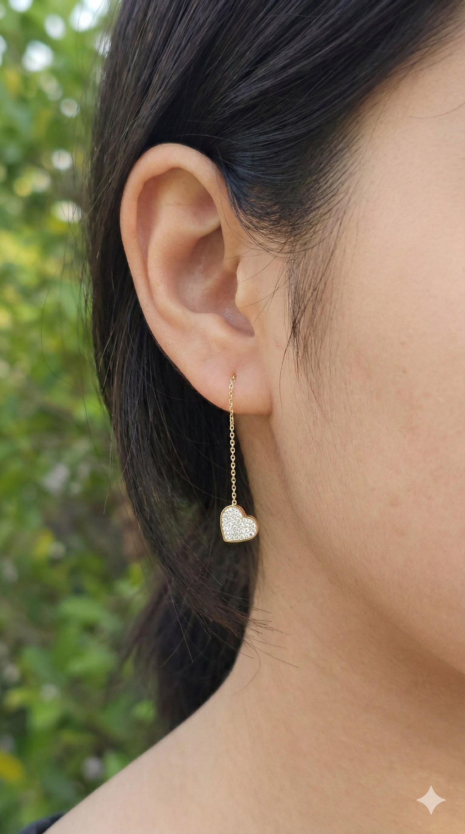 young woman wearing gold-plated hypoallergenic earrings, showing their anti-tarnish shine suitable for sensitive skin and daily wear