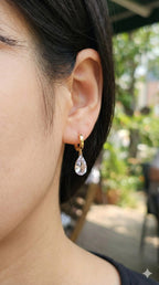 young woman wearing gold-plated hypoallergenic earrings, showing their anti-tarnish shine suitable for sensitive skin and daily wear
