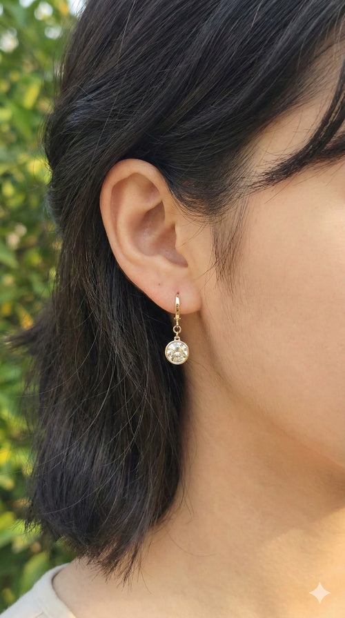 young woman wearing gold-plated hypoallergenic earrings, showing their anti-tarnish shine suitable for sensitive skin and daily wear