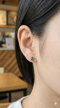 young woman wearing gold-plated hypoallergenic earrings, showing their anti-tarnish shine suitable for sensitive skin and daily wear