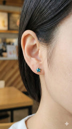 young woman wearing gold-plated hypoallergenic earrings, showing their anti-tarnish shine suitable for sensitive skin and daily wear