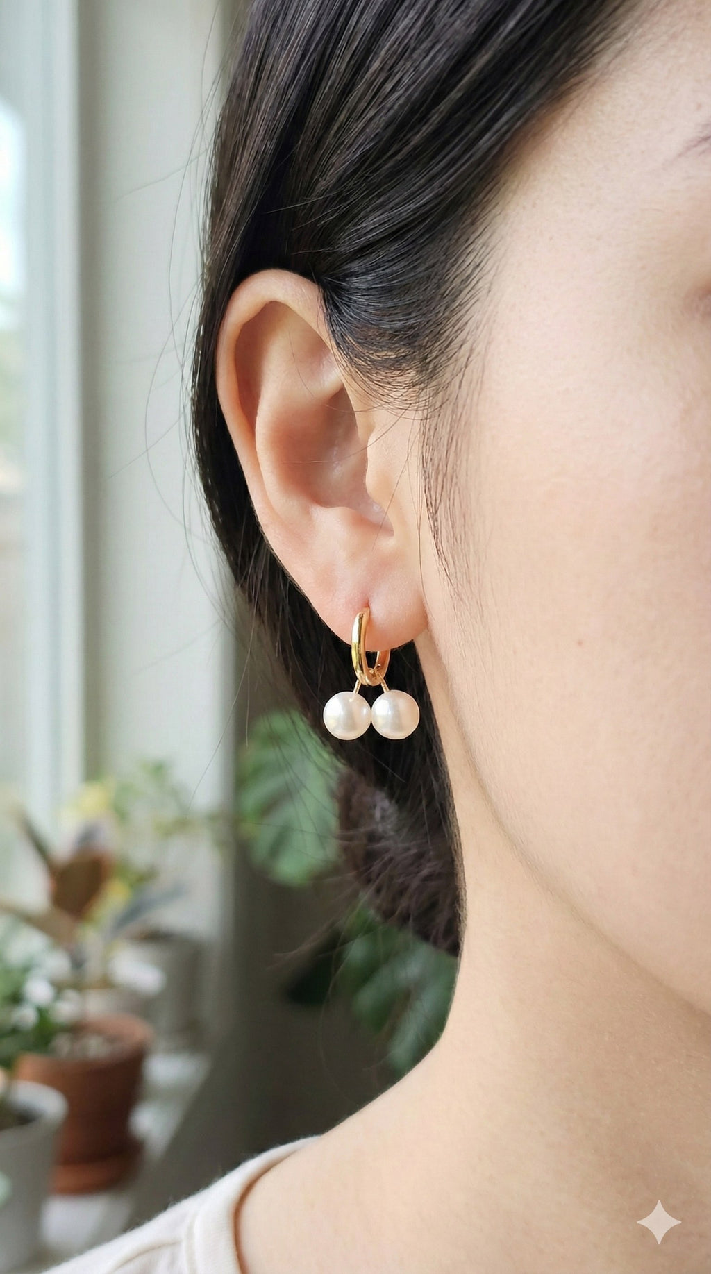 young woman wearing gold-plated hypoallergenic earrings, showing their anti-tarnish shine suitable for sensitive skin and daily wear