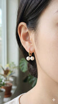 young woman wearing gold-plated hypoallergenic earrings, showing their anti-tarnish shine suitable for sensitive skin and daily wear