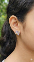 young woman wearing gold-plated hypoallergenic earrings, showing their anti-tarnish shine suitable for sensitive skin and daily wear