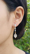 young woman wearing gold-plated hypoallergenic earrings, showing their anti-tarnish shine suitable for sensitive skin and daily wear