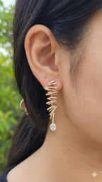 young woman wearing gold-plated hypoallergenic earrings, showing their anti-tarnish shine suitable for sensitive skin and daily wear