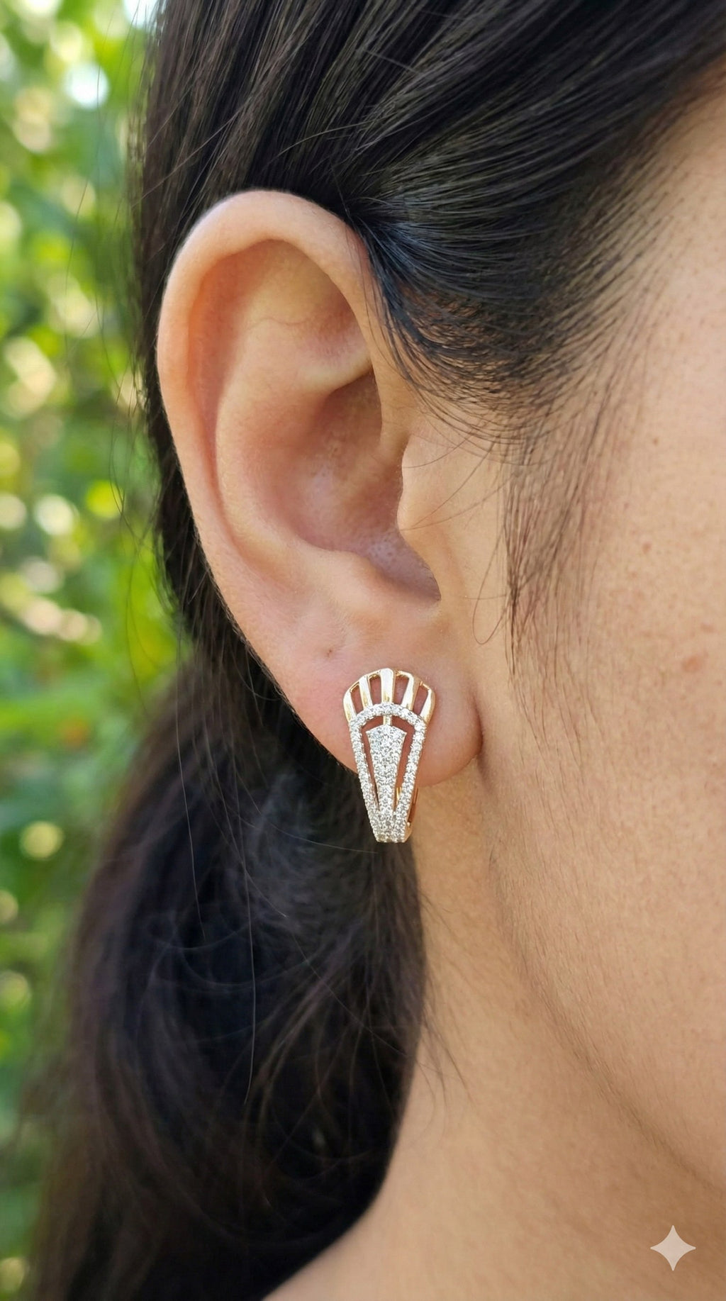 young woman wearing gold-plated hypoallergenic earrings, showing their anti-tarnish shine suitable for sensitive skin and daily wear