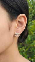 young woman wearing gold-plated hypoallergenic earrings, showing their anti-tarnish shine suitable for sensitive skin and daily wear