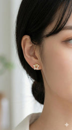 young woman wearing gold-plated hypoallergenic earrings, showing their anti-tarnish shine suitable for sensitive skin and daily wear
