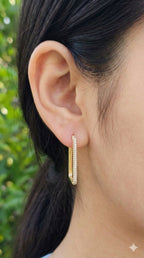 young woman wearing gold-plated hypoallergenic earrings, showing their anti-tarnish shine suitable for sensitive skin and daily wear