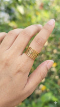 young woman wearing gold-plated hypoallergenic finger ring, showing their anti-tarnish shine suitable for sensitive skin and daily wear