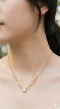 young woman wearing gold-plated hypoallergenic necklace, showing their anti-tarnish shine suitable for sensitive skin and daily wear