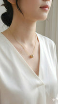young woman wearing gold-plated hypoallergenic necklace, showing their anti-tarnish shine suitable for sensitive skin and daily wear